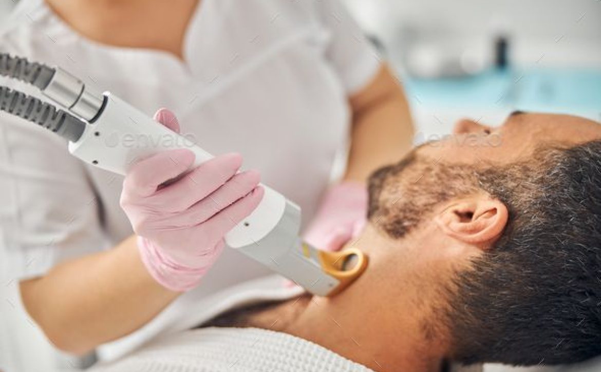 Unshaven young man having laser hair removal procedure