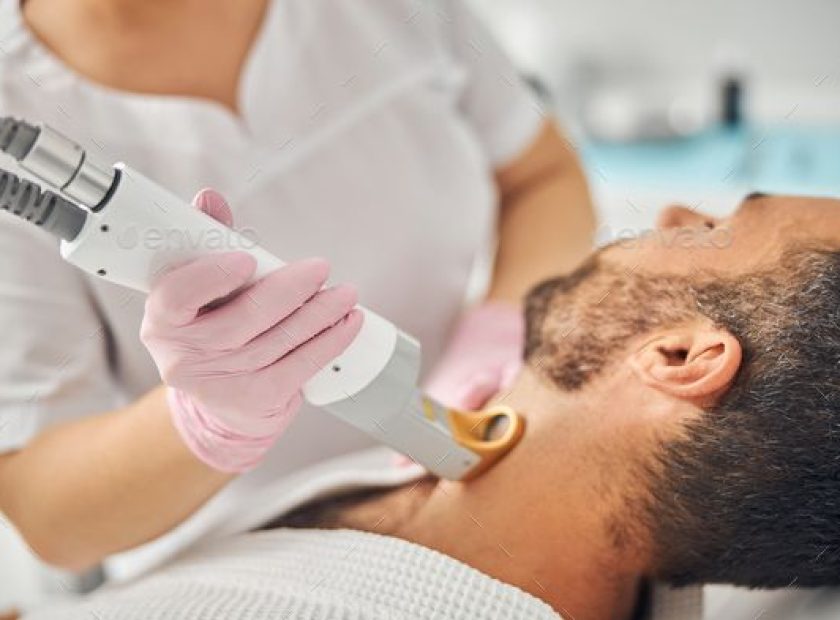 Unshaven young man having laser hair removal procedure